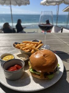 A picture of a hamburger with the ocean in the background