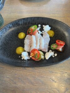 Hamachi with radish, cucumber, toy box tomatoes, jalapenos, mango gelee, olive oil, lemon snow